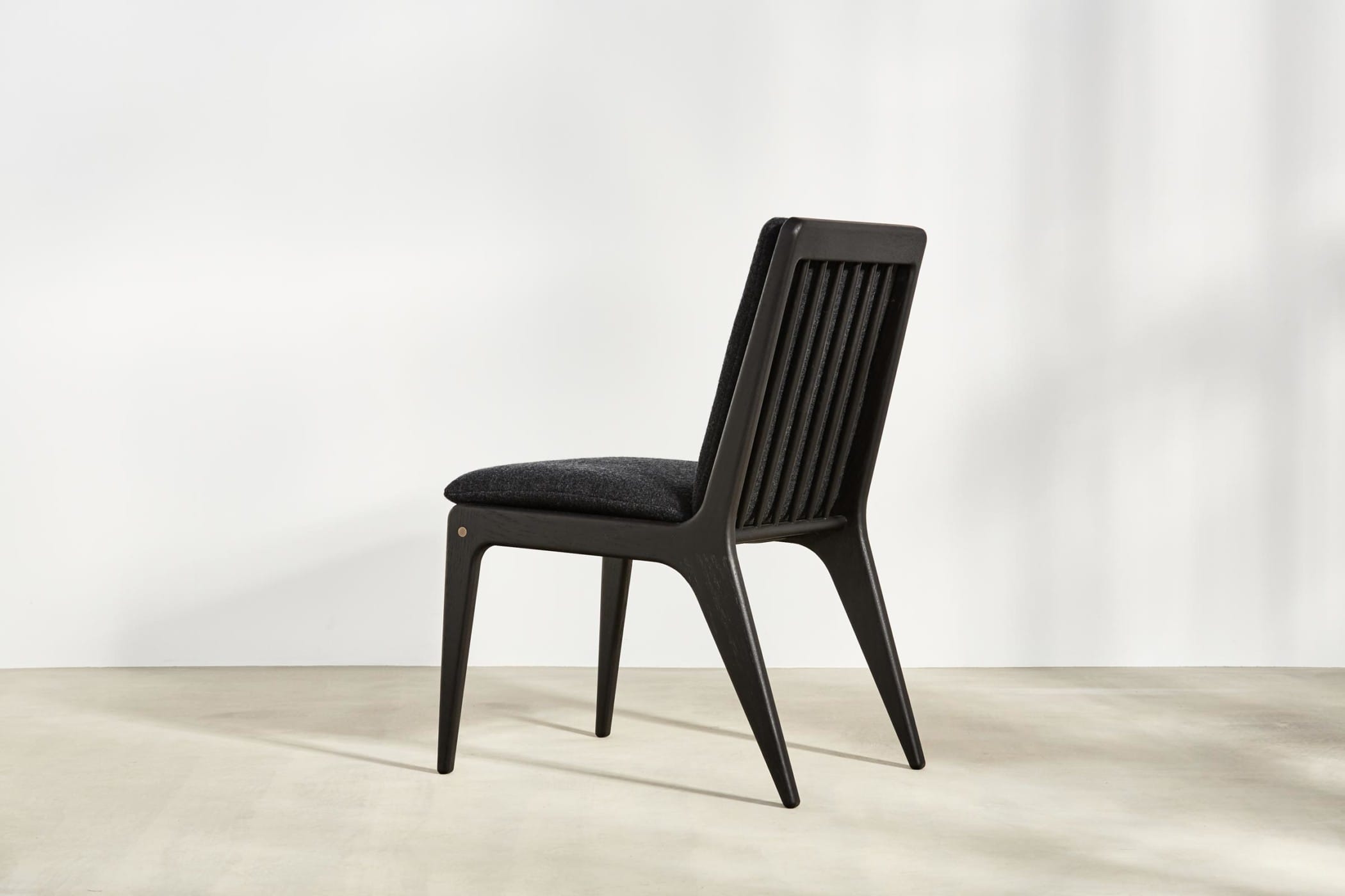 spindle backed chair with black leather upholsterery