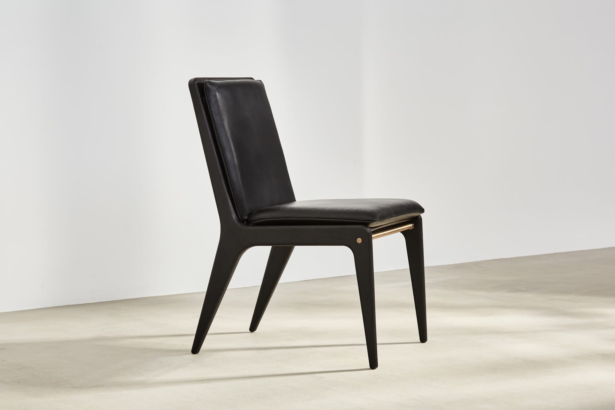 spindle backed chair with black leather upholsterery