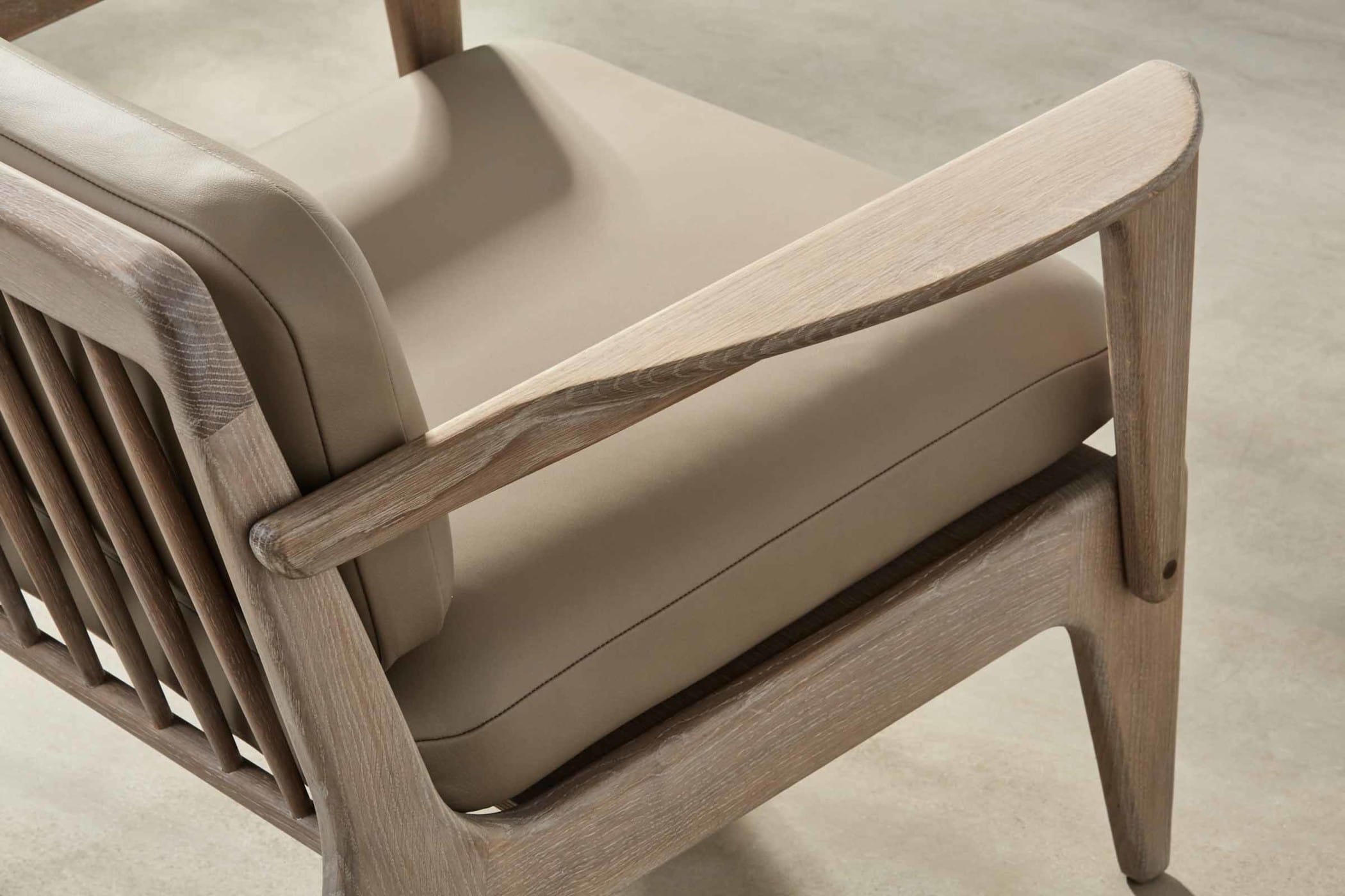 light grey armchair with light grey leather upholstery