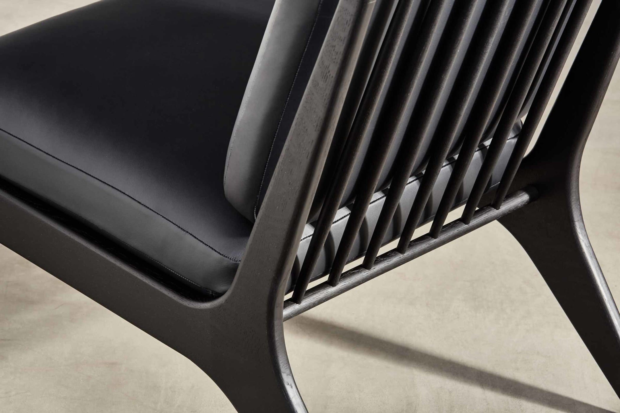 black medium chair with black leather upholstery