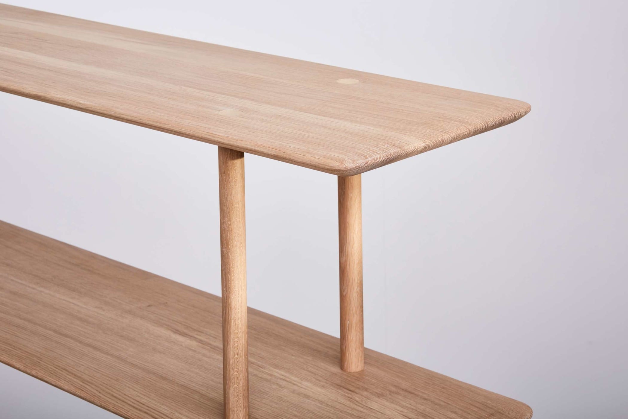 two oak shelves with brass details on top