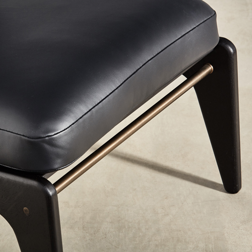 brass detailing on ebonised chair with leather upholstery