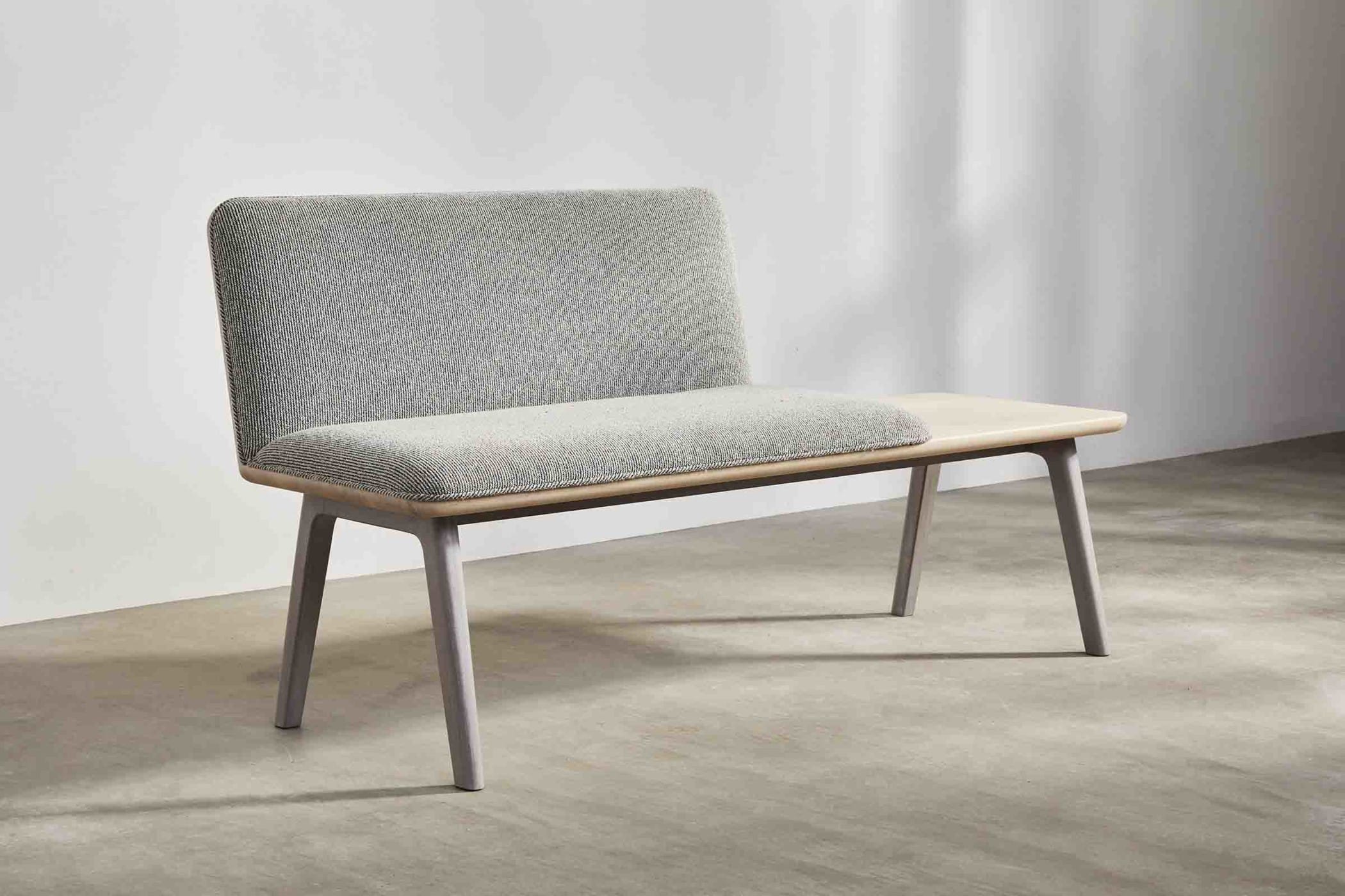 oak bench with light grey upholstery with build in side table