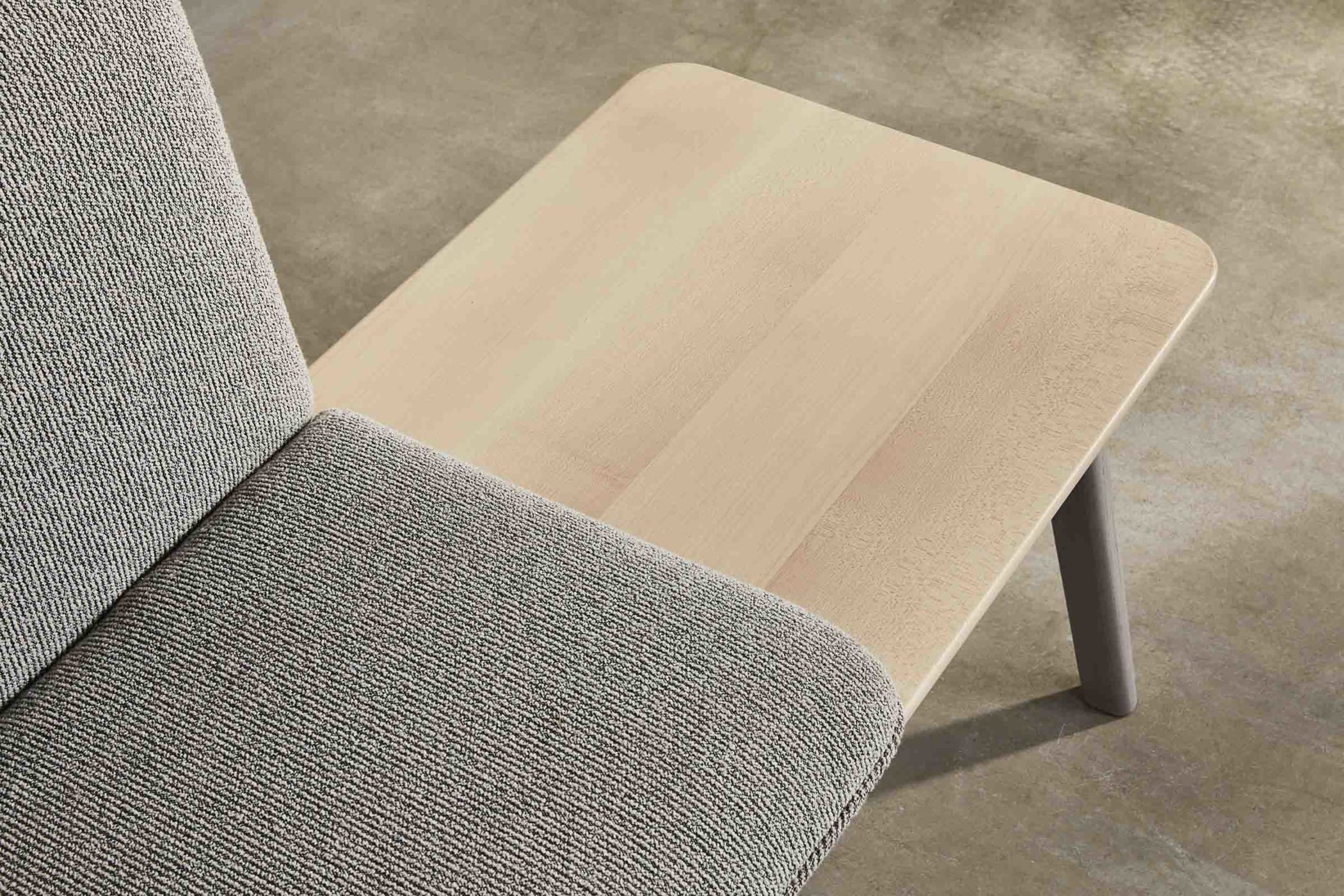 side table built into an oak bench with light grey upholstery