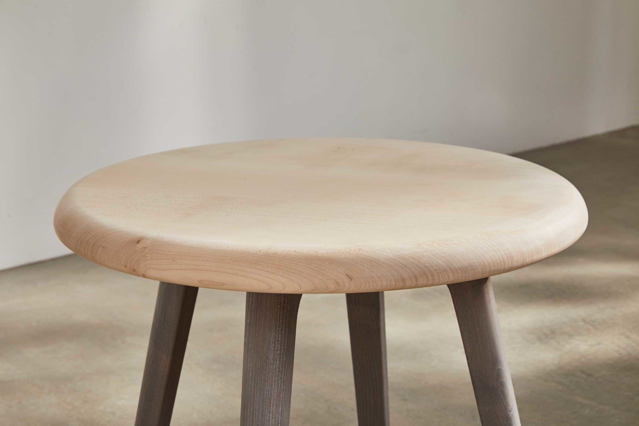 circular side table with a sycamore top and an ash underframe