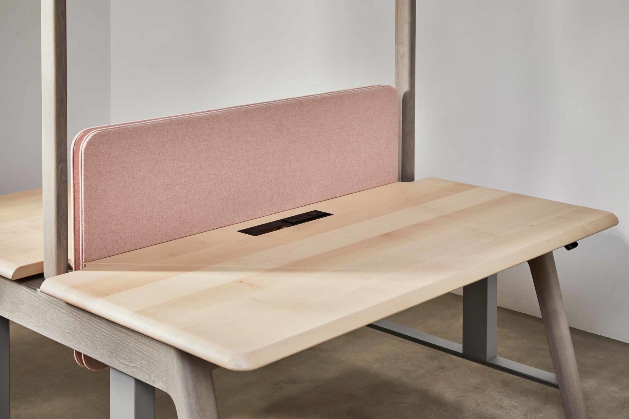 sit-stand workbench made from sycamore and ash with a light pink felt board